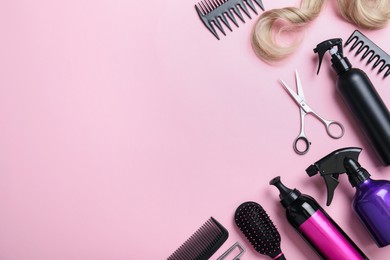 Professional hairdresser scissors and other equipment on pink background, flat lay with space for text. Haircut tools