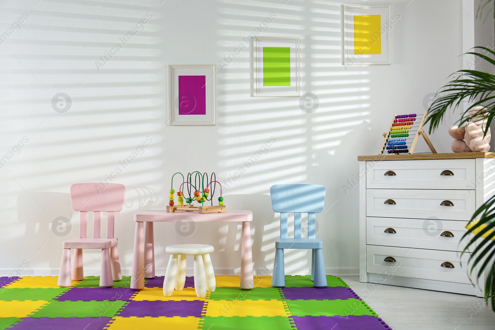 Photo of Stylish playroom interior with toys and modern furniture