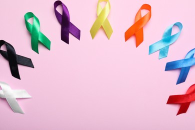 Photo of Colorful ribbons on pink background, flat lay with space for text. World Cancer Day