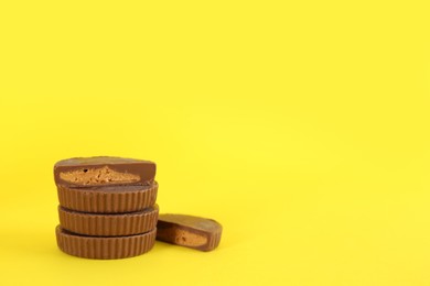 Sweet peanut butter cups on yellow background. Space for text