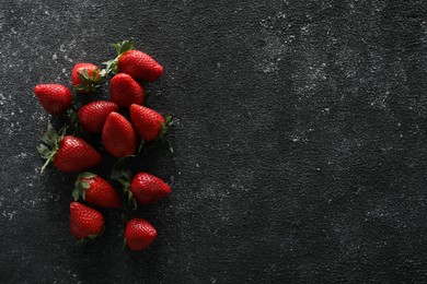 Photo of Food photography. Delicious ripe strawberries on black textured table, flat lay with space for text