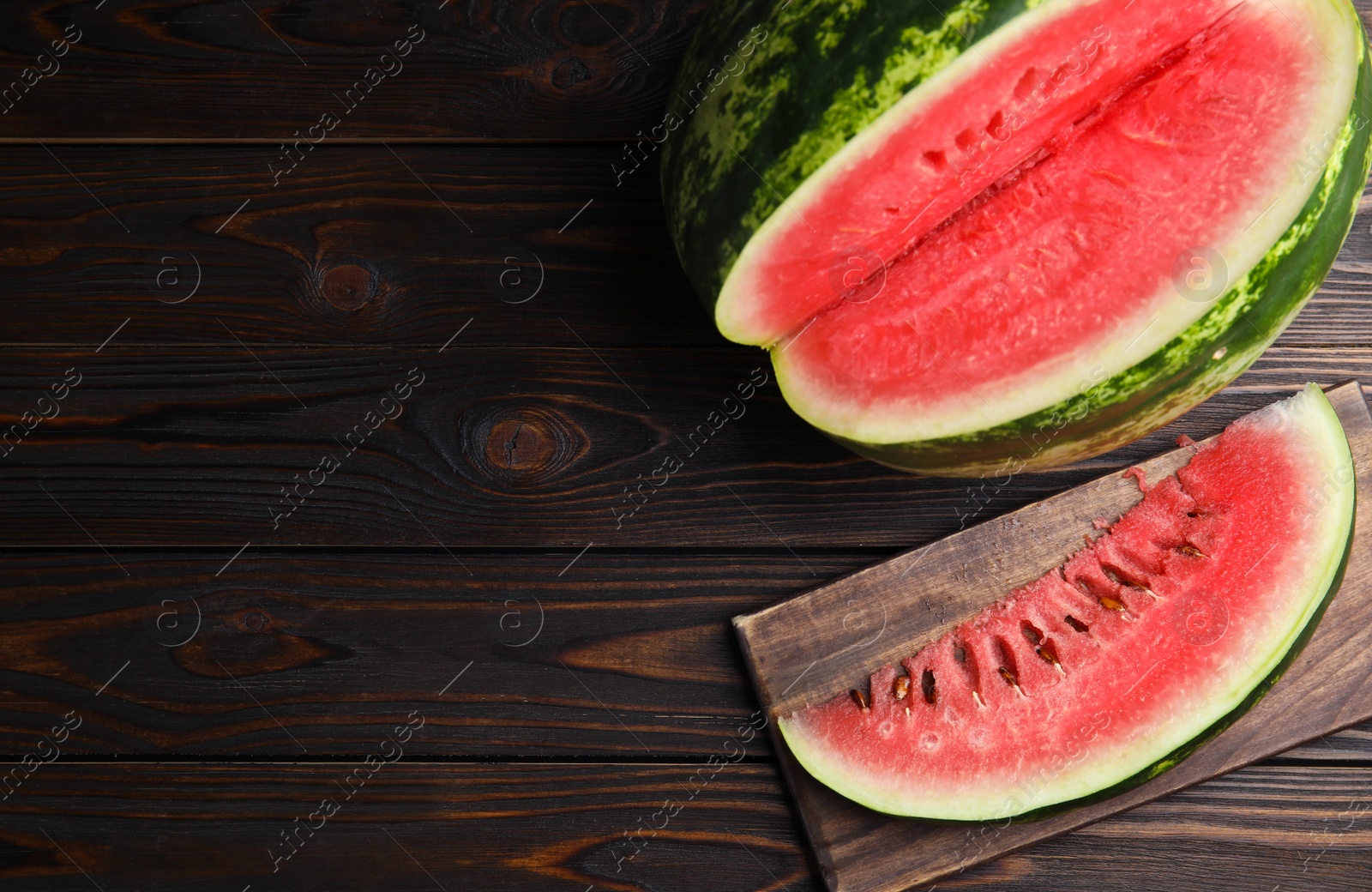 Photo of Yummy watermelon on wooden table, flat lay. Space for text