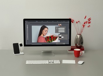 Image of Designer's workplace. Computer with photo editor application on table 