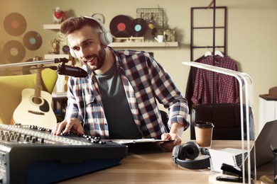 Photo of Man working as radio host in modern studio