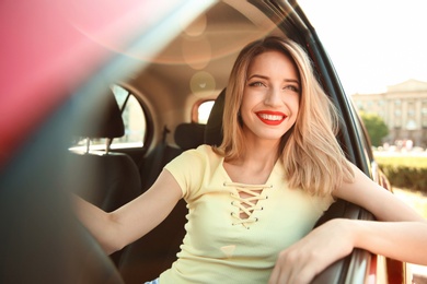 Young woman on driver's seat of car