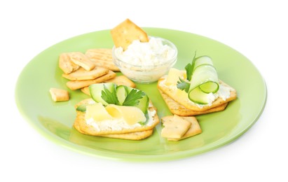Delicious crackers with cream cheese, cucumber and parsley on white background