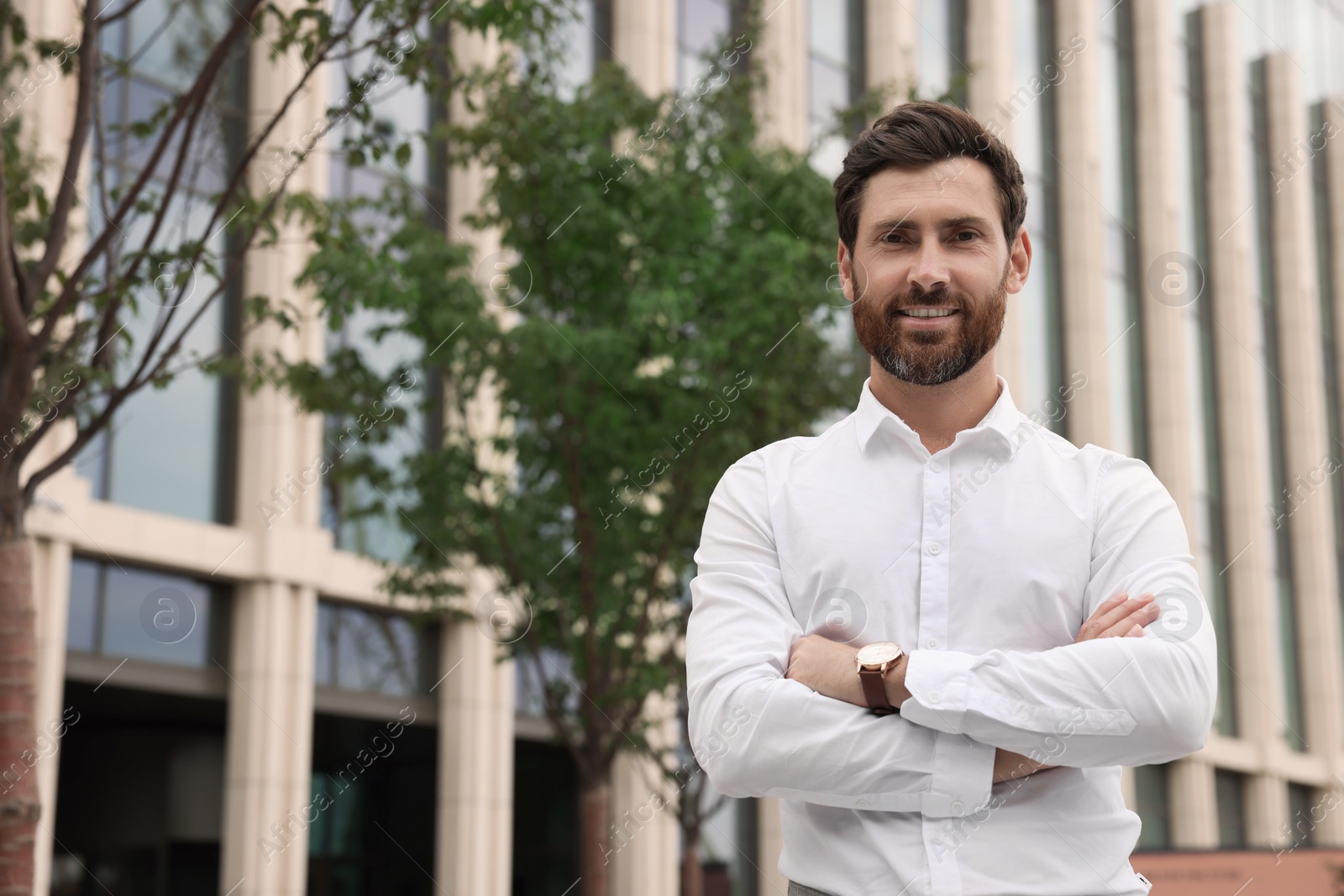 Photo of Portrait of handsome bearded man on city street, space for text