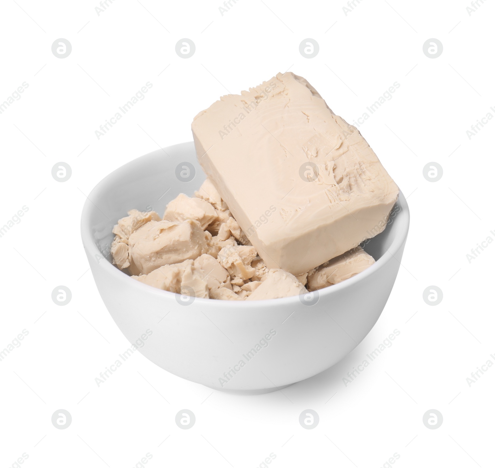 Photo of Pieces of compressed yeast in bowl isolated on white