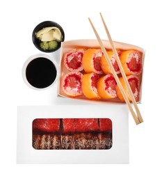 Photo of Paper boxes with different delicious sushi rolls on white background, top view. Food delivery