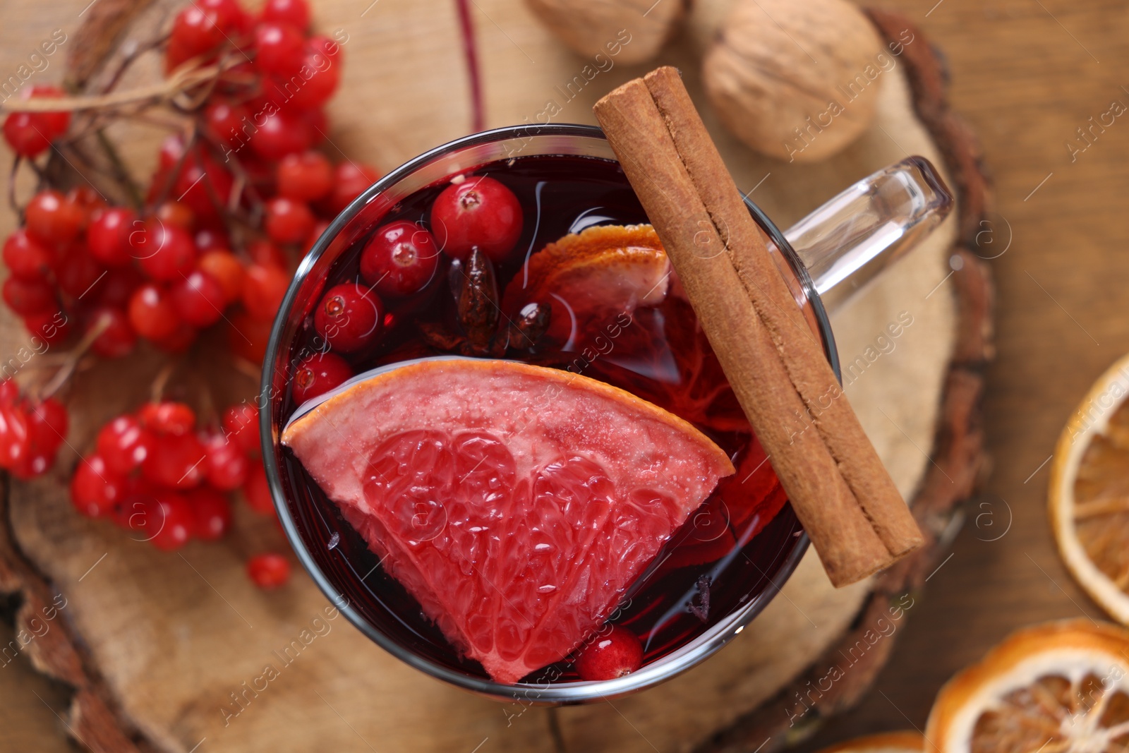 Photo of Aromatic mulled wine in glass cup on table, flat lay