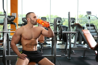 Photo of Portrait of athletic man drinking protein shake in gym