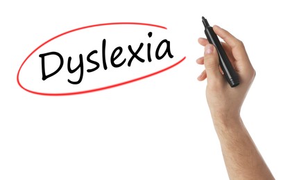 Image of Man writing word Dyslexia on white background, closeup