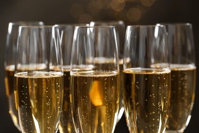 Many glasses of champagne on blurred background, closeup