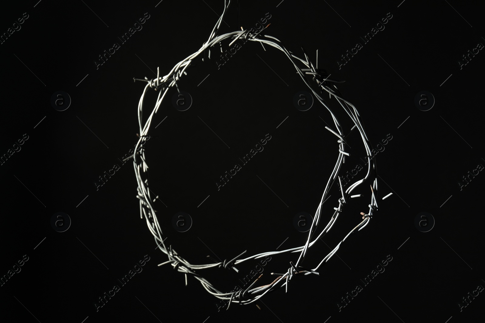 Photo of Shiny metal barbed wire on black background