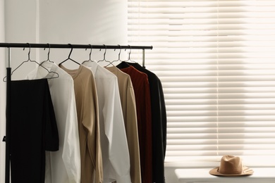 Photo of Rack with stylish men's clothes indoors. Interior design
