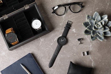 Photo of Flat lay composition with stylish wrist watches on table. Fashion accessory