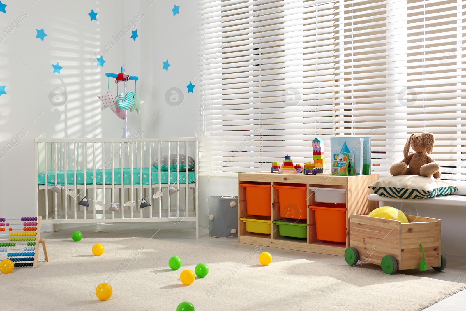 Photo of Cozy baby room interior with comfortable crib