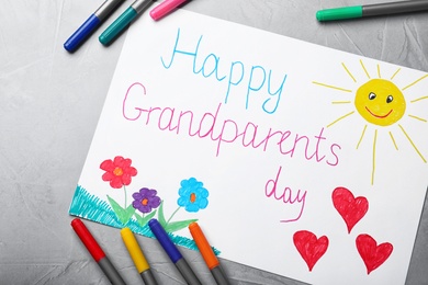 Photo of Beautiful drawing on grey table, flat lay. Happy Grandparents Day