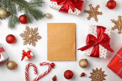 Photo of Flat lay composition with empty card and Christmas decoration on white background. Writing letter to Santa Claus