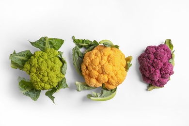 Photo of Colorful cauliflower cabbages on white background. Healthy food