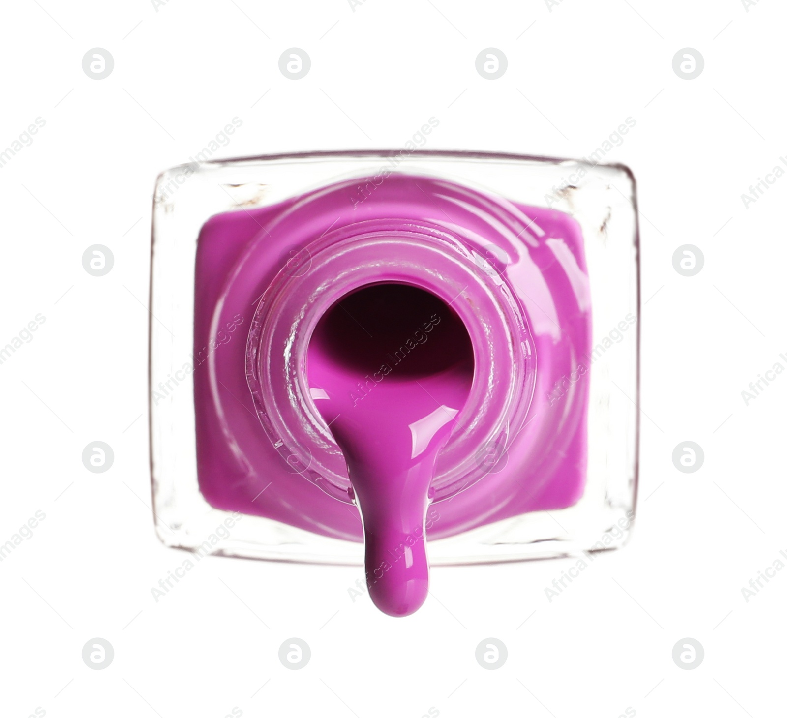 Photo of Pouring color nail polish from bottle on white background
