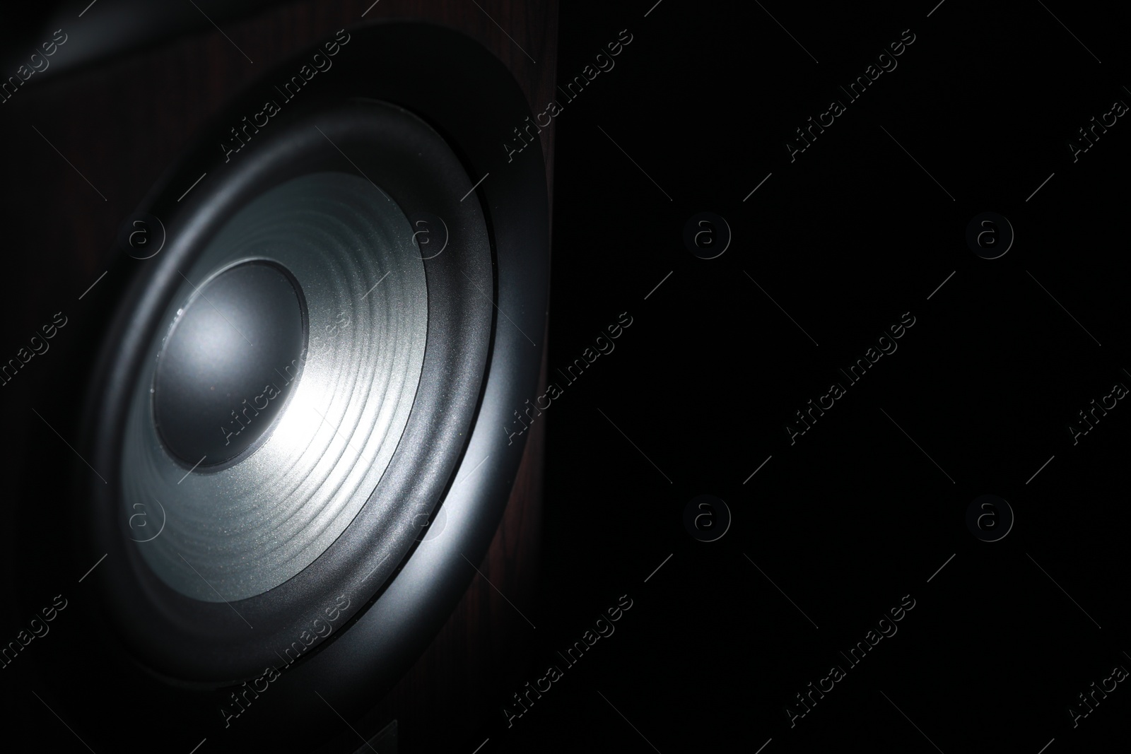 Photo of One sound speaker on black background, closeup. Space for text