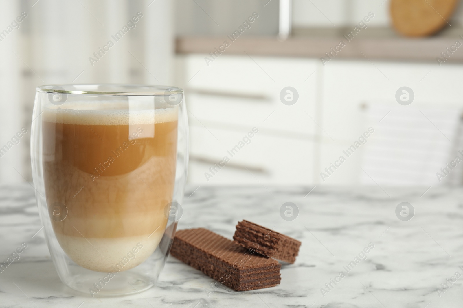 Photo of Delicious wafers and coffee for breakfast on white marble table indoors. Space for text
