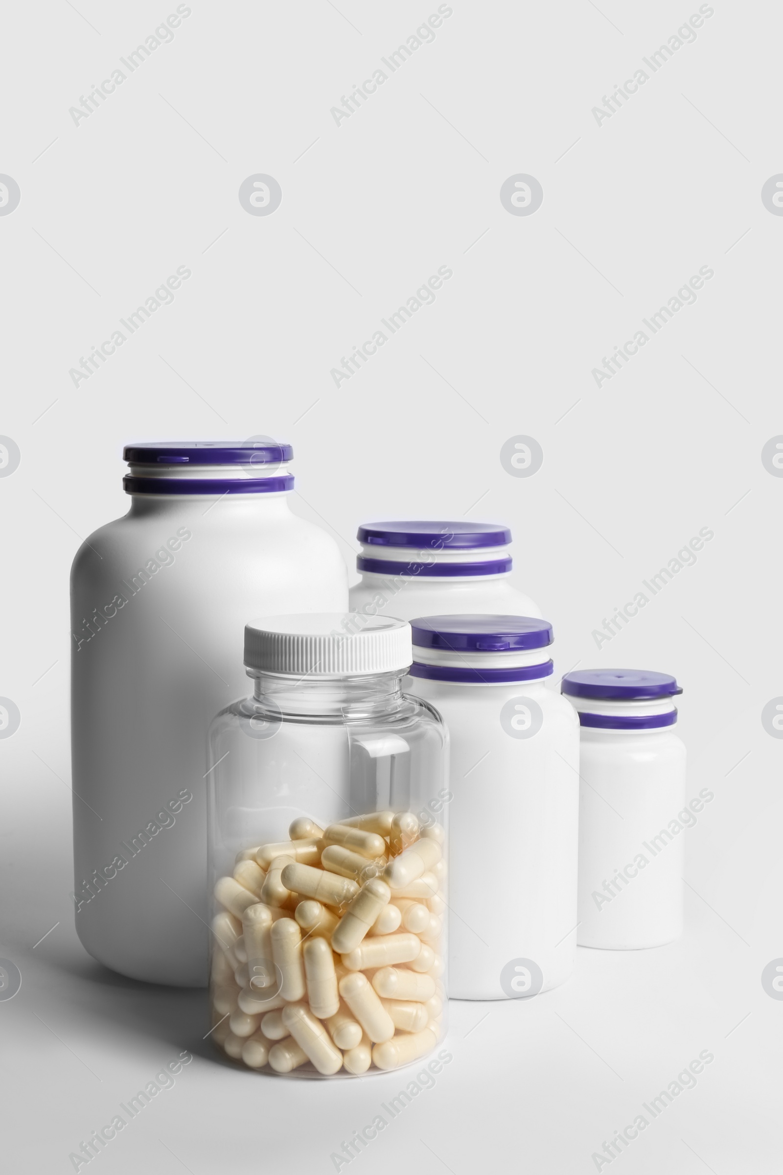 Photo of Many different medicine bottles on white background. Medicament