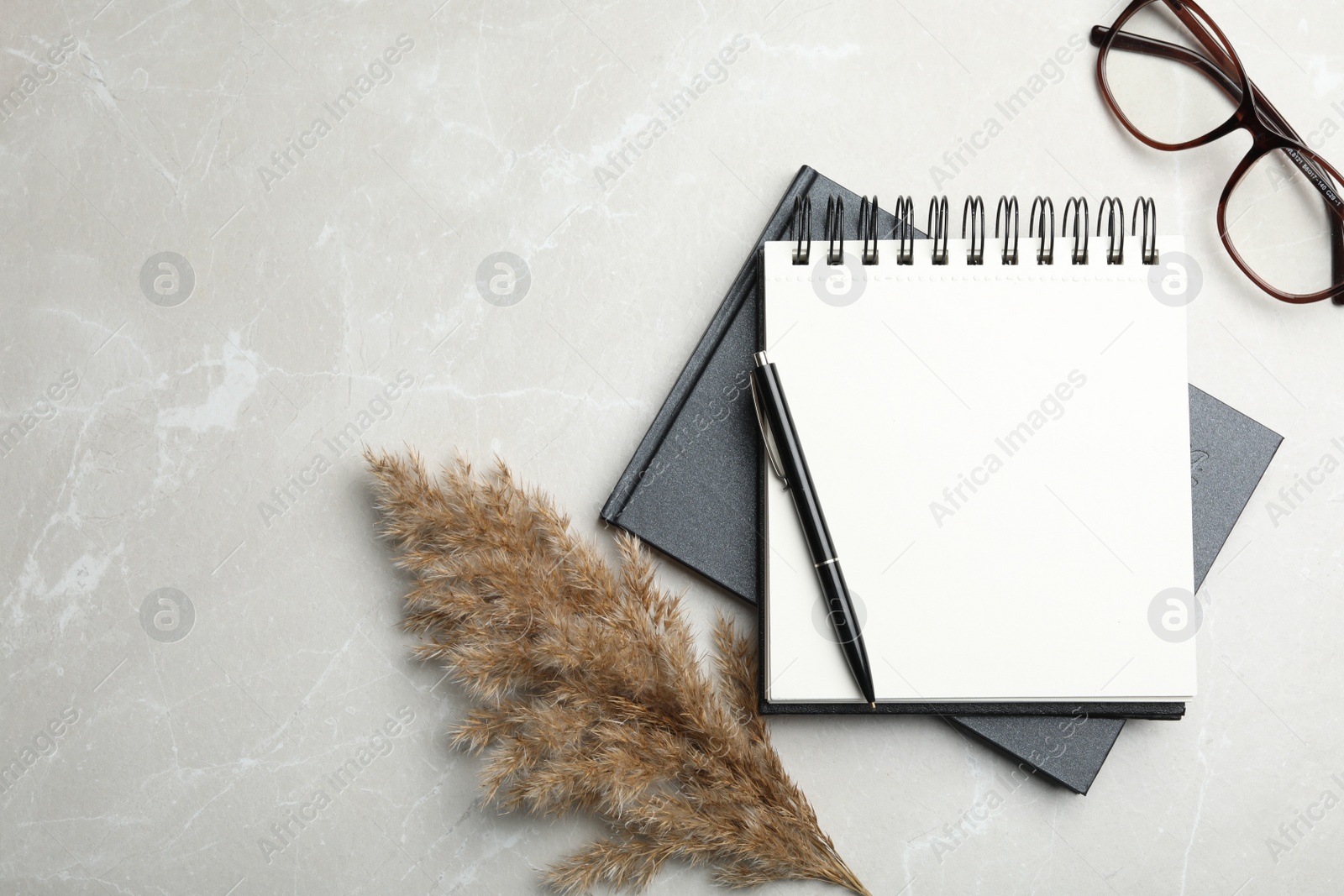 Photo of Flat lay composition with stylish notebooks on marble table