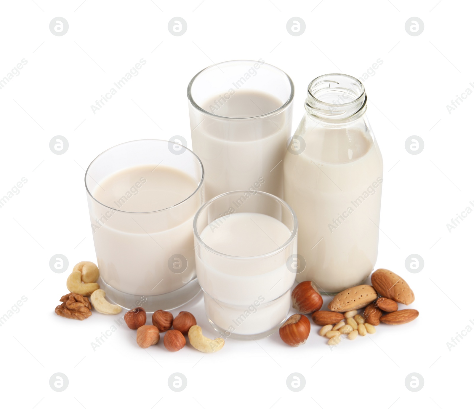 Photo of Vegan milk and different nuts on white background