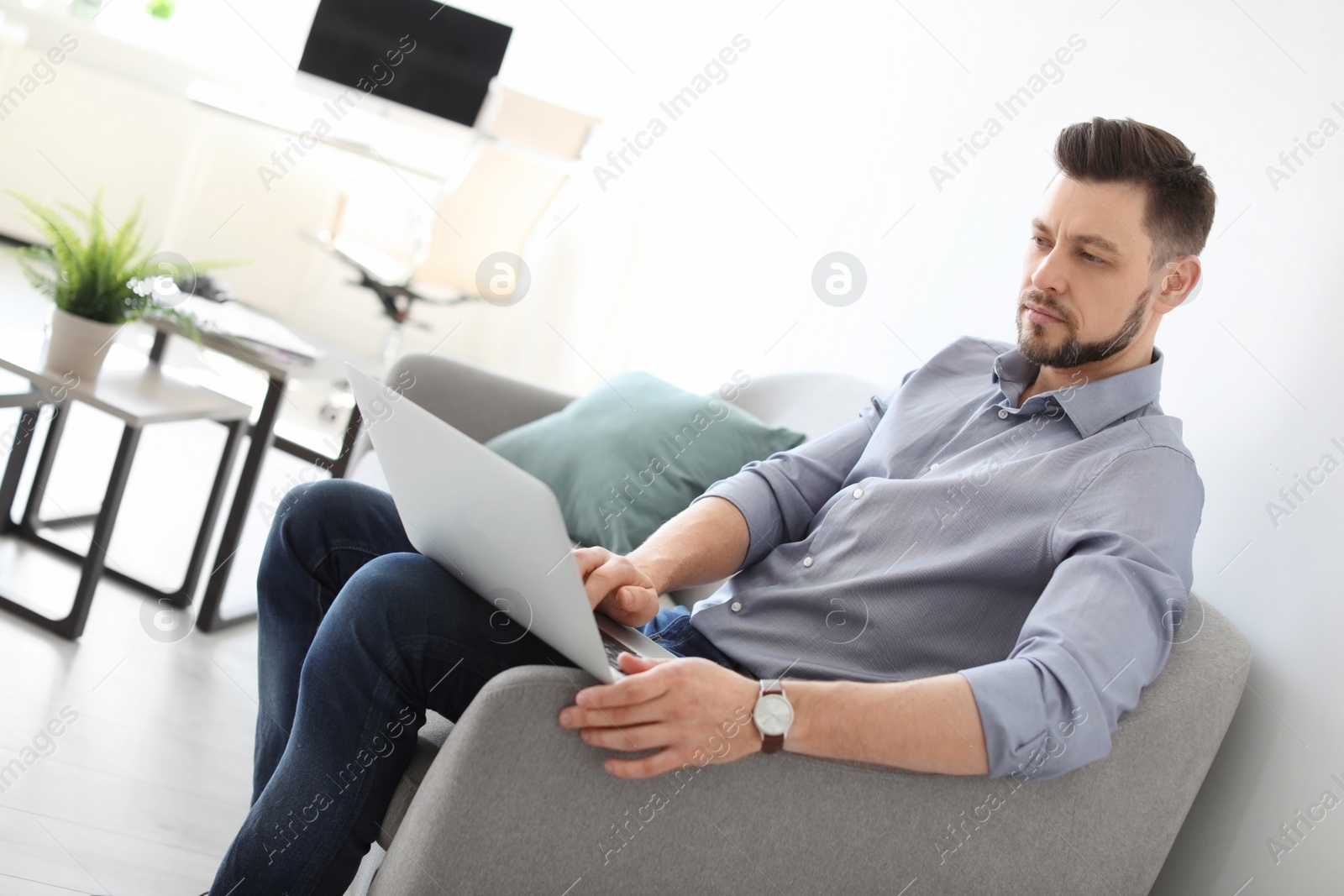 Photo of Male lawyer working with laptop in office