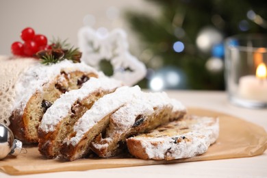 Traditional Christmas Stollen with icing sugar on white table