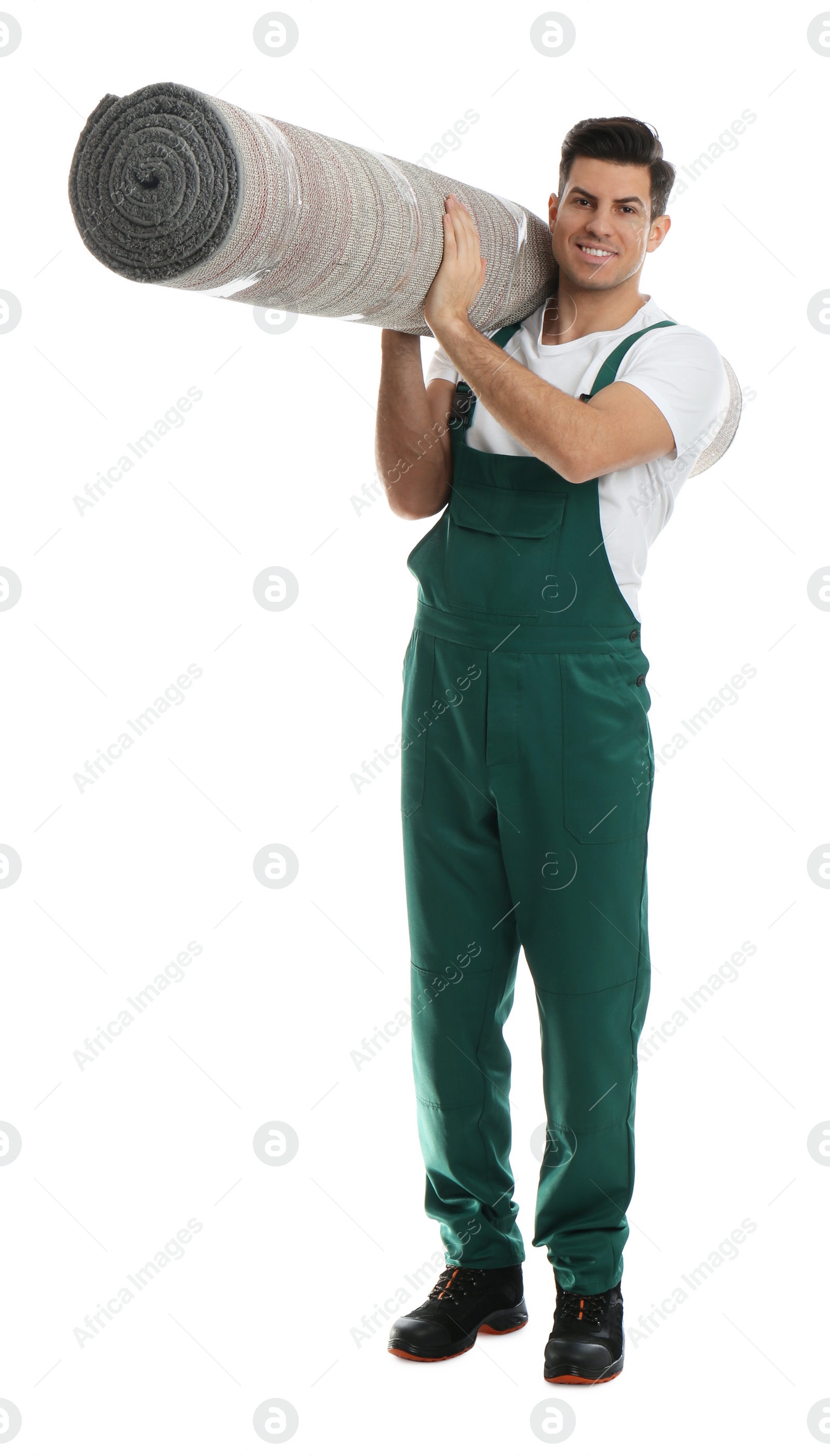 Photo of Male worker with rolled carpet on white background