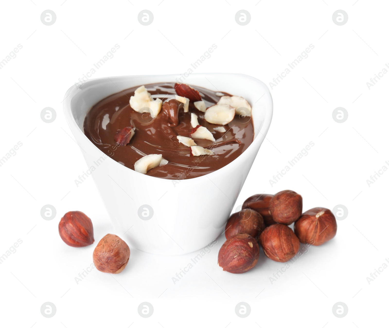 Photo of Dessert bowl with chocolate cream and hazelnuts isolated on white