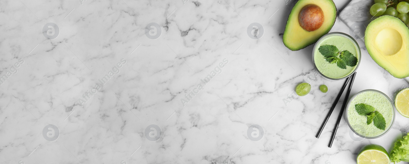 Image of Flat lay composition with tasty avocado smoothie on marble table, space for text. Banner design