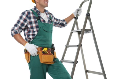 Photo of Professional builder near metal ladder on white background, closeup
