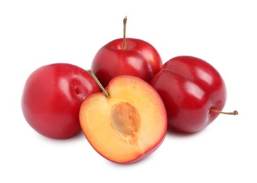 Photo of Cut and whole cherry plums on white background