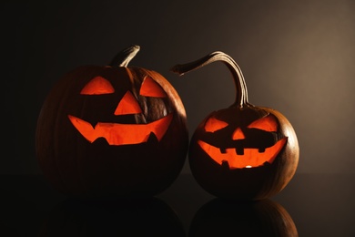 Halloween pumpkin heads. Glowing jack lanterns on dark background