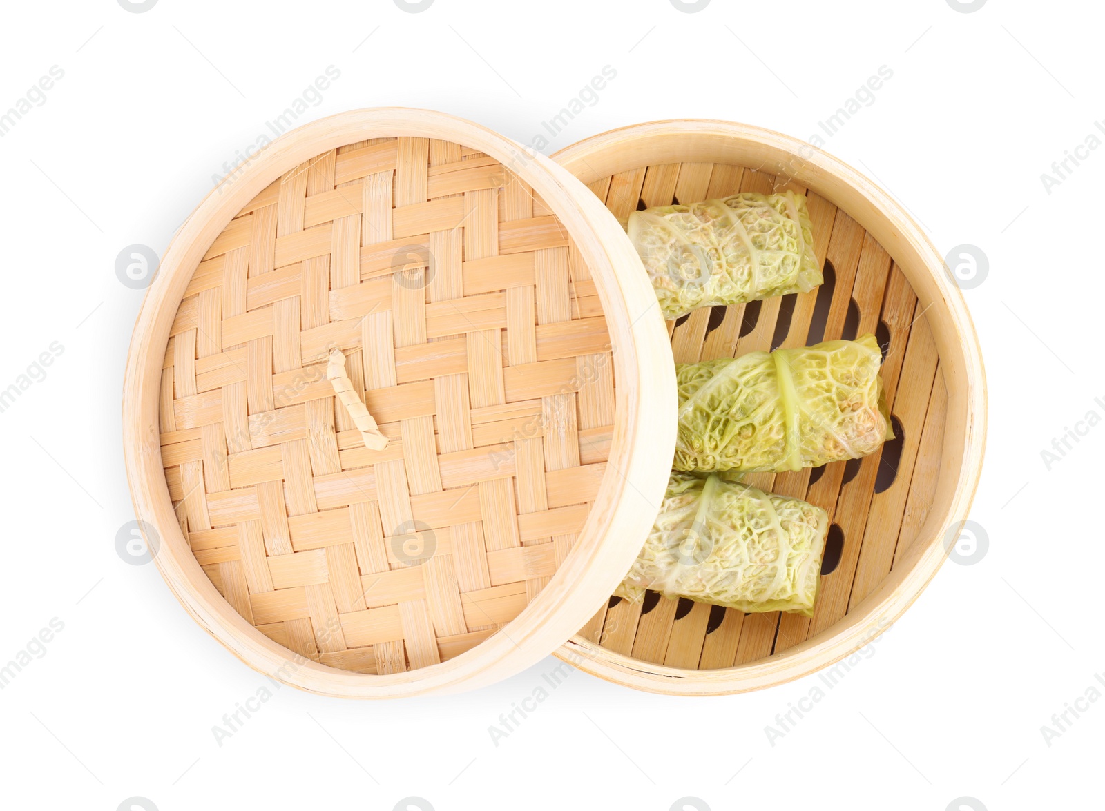 Photo of Delicious cabbage rolls in bamboo steamer isolated on white, top view