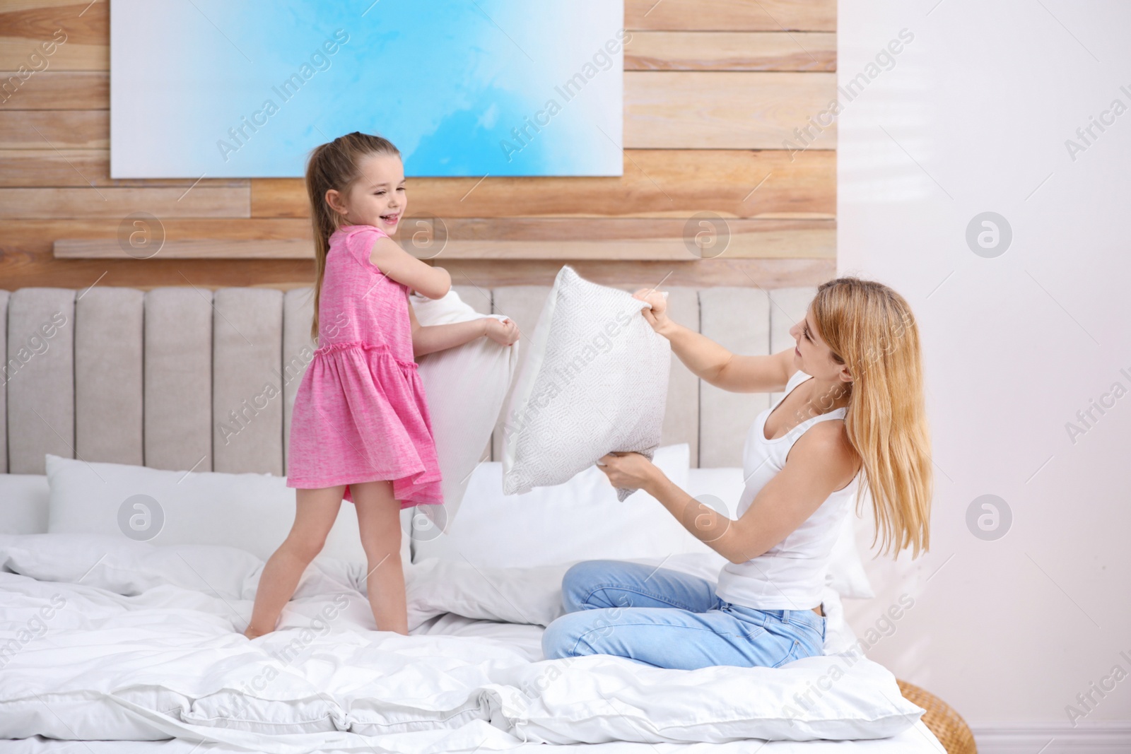 Photo of Mother playing with her child in bedroom at home