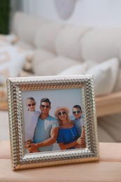Photo of Framed family photo on wooden table in living room