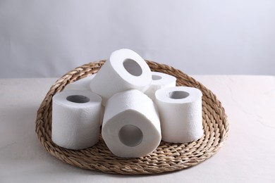 Photo of Many toilet paper rolls on white table