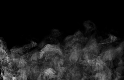 White steam rising in air on black background