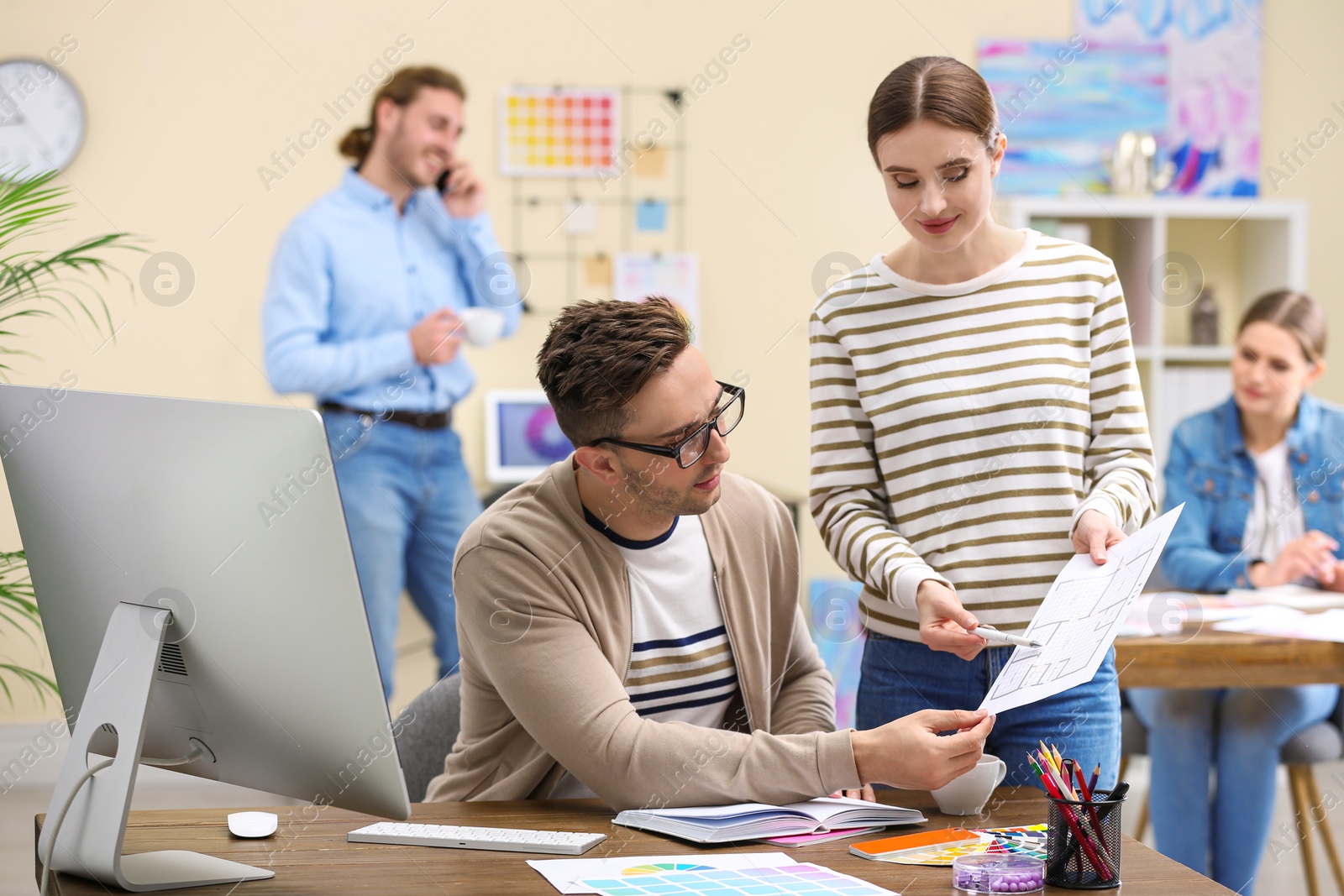 Photo of Professional interior designer with colleague working in office