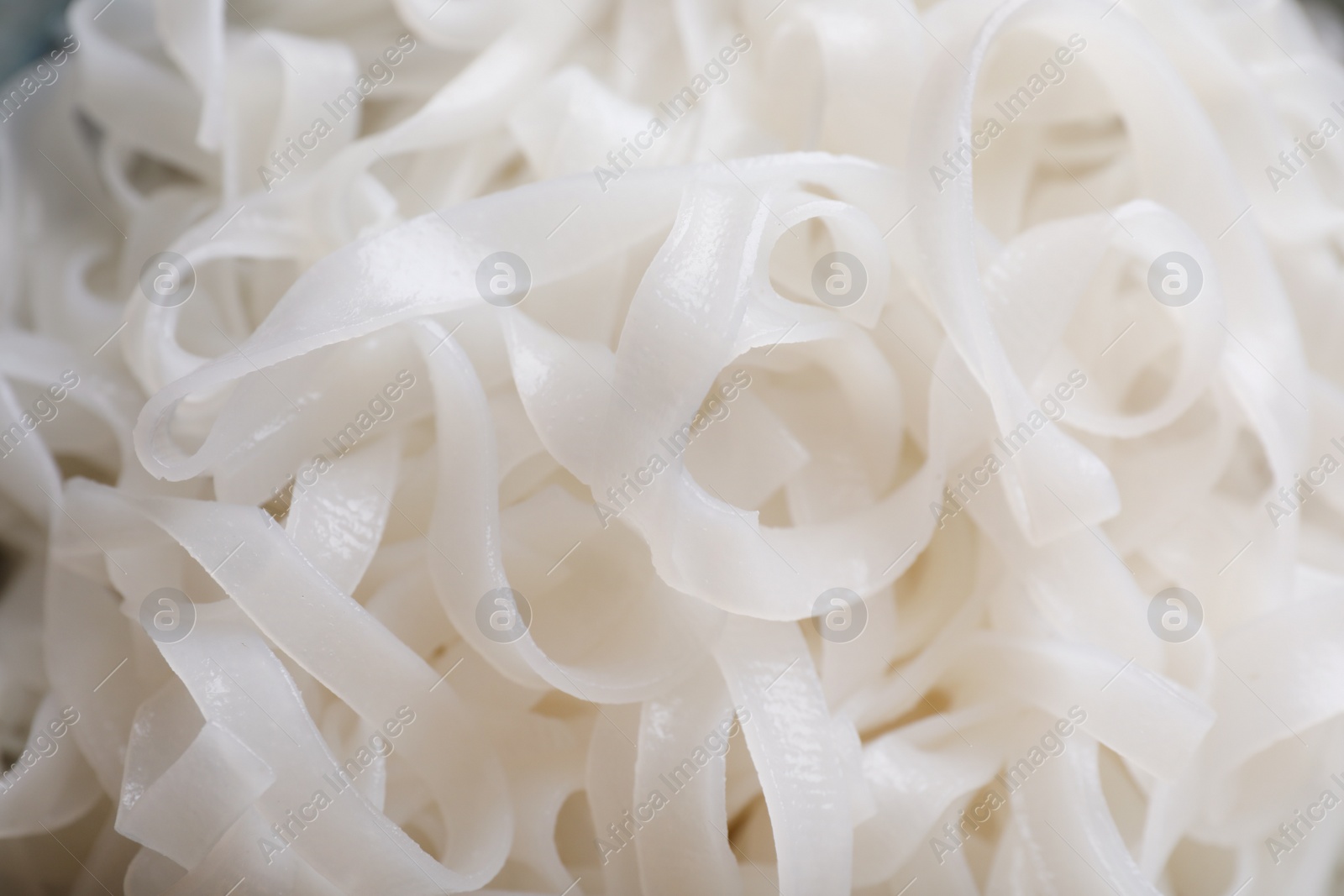 Photo of Tasty cooked rice noodles as background, closeup