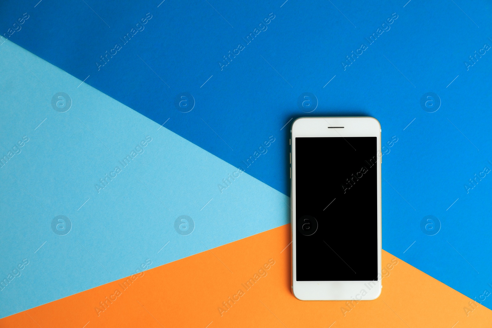 Photo of Modern phone on color background, top view. Space for text