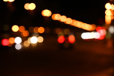 Blurred view of road with cars at night. Bokeh effect