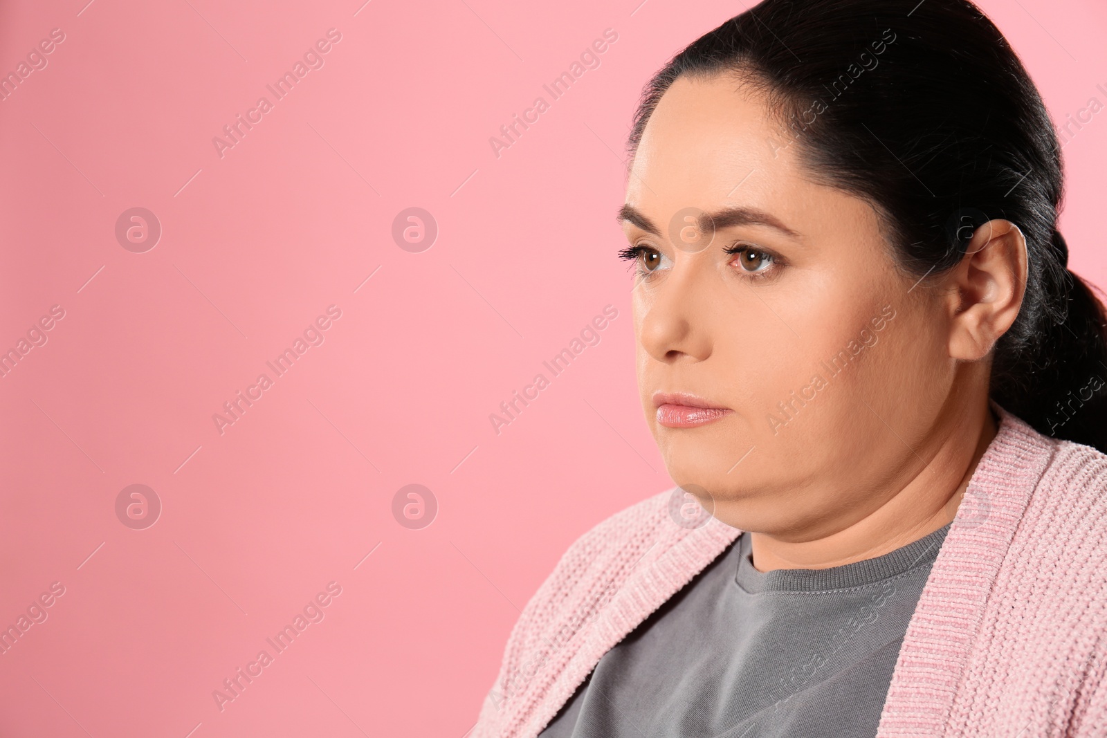 Photo of Woman with double chin on pink background. Space for text