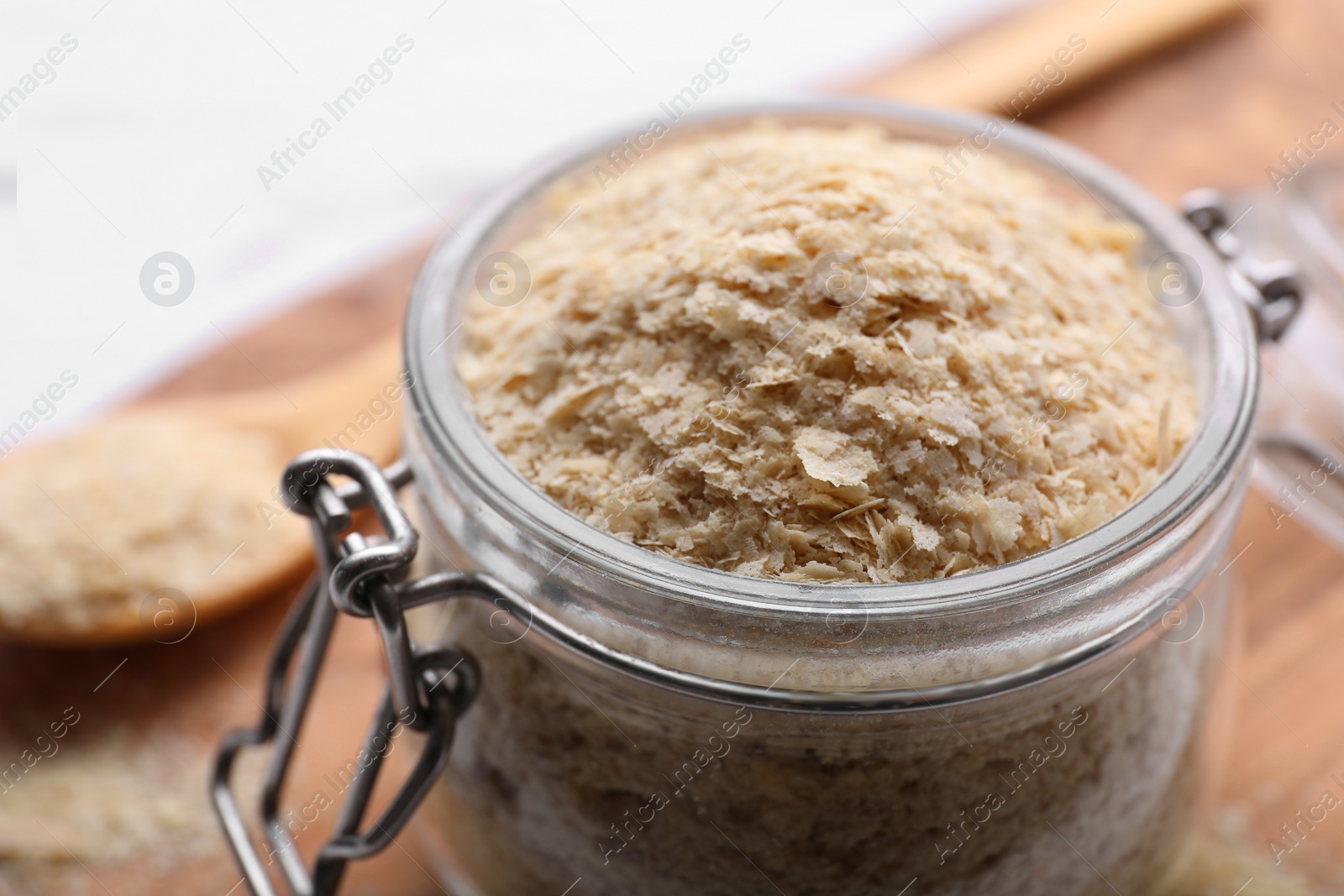 Photo of Beer yeast flakes on white wooden table, closeup