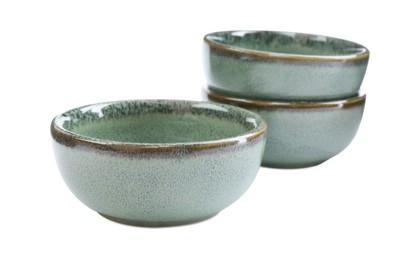 Beautiful green ceramic bowls on white background